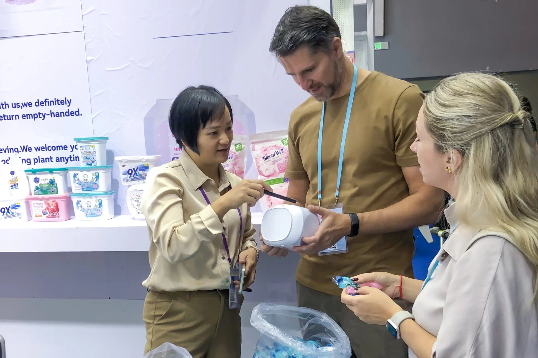AUTHENTIC team discussing packaged laundry products with trade show visitors